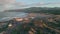 Serene beach road sunset light. Aerial view of coastal town nestle rugged cliffs