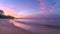 Serene beach sunset with colorful skies and gentle waves