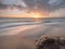 A serene beach sunset, tranquil, coastline, horizon, ocean waves, golden hour