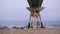 Serene and calm young woman finish yoga asana practice at the beach.