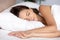 Serene calm young woman sleeping well on orthopedic soft pillow