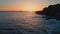 Serene coast rippling ocean shaking sunset drone view. Rocky cliffs landscape
