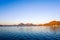 Serene dawn shot of lake with mountains in the distance