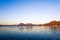 Serene dawn shot of lake with mountains in the distance