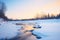 serene dusk light on a half icy-half flowing river