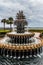 Serene fountain rests in the center of a verdant park, with towering palms encircling the area