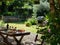 Serene garden picnic with wine and grilled food