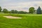 Serene Golf Course with Sand Bunker and Lush Fairway at Dawn