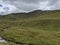 Serene Highland Landscape Overlooking a Lake with Scenic Cloudy Skies