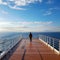 A serene image of a lone figure standing on the deck of a cruise ship