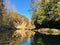 Serene image of a river flowing through an autumnal landscape