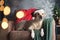 Serene Labrador Retriever in a Santa hat lounges on a sofa