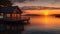 A serene lakeside cabin with a beautiful view of the sunset reflecting on the water