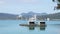 Serene Lakeside View with Floating Huts and Distant Mountains