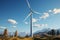 Serene landscape with wind turbines spinning gracefully under light blue skies in a peaceful setting