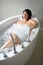 Serene mature woman with her eyes closed in a bathtub