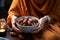 A serene moment as a Muslim woman holds a bowl of dates to break her fast