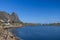 A serene Nordic seascape at Lofoten, Norway, under a clear sky with a sunlit bridge connecting rocky shores