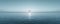 Serene ocean landscape with a crystal sphere reflecting sunlight