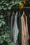 Serene outdoor setting with various pieces of clothing hanging on hangers.