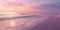 Serene pink sunset over gentle waves on a sandy beach.