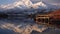 Serene Reflections of Snow-Capped Mountains on a Tranquil Lake