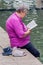 Serene Retreat: Senior Woman Enjoying a Book in a Spa Wellness Park