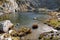 Serene river surrounded by rocky terrain