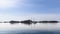 A serene sailboat rests in Norway\\\'s Lofoten waters under a clear sky