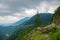 Serene Sanctuary: Blue Skies Caress the Verdant Mountain Tops