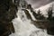 Serene scene of a pristine waterfall, with cascading white water pouring down