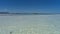 Serene seascape. The sandy bottom is visible through the clear turquoise water.