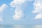 Serene seascape with white fluffy clouds above the sea