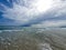 Serene seaside landscape with sky with clouds and waves