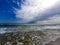 Serene seaside landscape with sky with clouds and waves