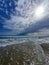 Serene seaside landscape with sky with clouds and waves