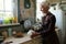 Serene senior woman holding teapot while brewing tea for her guests