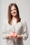 Serene smiling woman with a gift in her hands