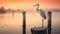 Serene Sunrise: A Heron Perched On A Historic Wooden Beam