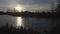 Serene Sunset Over a Frozen Lake with Scenic Silhouettes