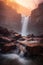 Serene Sunset Waterfall Between Rocks