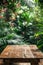 Serene Tropical Garden View with Wooden Table Amidst Lush Greenery and Blooming Flowers