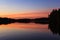 Serene view of calm lake and sunset clouds