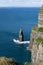 Serene view a rocky shoreline with blue ocean waters. Cliffs of Moher, Ireland.