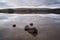 Serene water of Malham Tarn with the reflection of the afternoon sun on the hills, Yorkshire Dales,