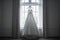 A serene white wedding dress hangs before a window, bathed in natural light, evoking elegance and anticipation of nuptials, ai