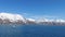 Serene Winter Landscape: Majestic Mountains, Pristine Snow, and Tranquil Sea a view from svalbard and jan mayen norway