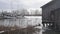 Serene Winter Waterscape with Boats and Dockside Cabin