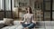 Serene woman do meditation practice sit on sofa at home