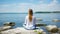 Serene woman engaging in yoga practice with breathtaking seashore view in the background